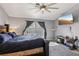 Bright main bedroom features neutral walls, carpet, updated fan, and entertainment center at 7621 Gosport Ave, Las Vegas, NV 89131