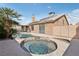 Inviting backyard with a swimming pool and hot tub, surrounded by mature palm trees at 7621 Gosport Ave, Las Vegas, NV 89131