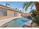 Backyard pool with waterfall feature, mature palms, and patio at 7621 Gosport Ave, Las Vegas, NV 89131