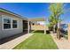 Spacious backyard with artificial turf, gravel, a pergola, and serene mural backdrop for outdoor enjoyment at 856 Watford Pl, Henderson, NV 89011
