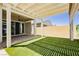 Outdoor living space featuring covered patio with artificial turf at 856 Watford Pl, Henderson, NV 89011