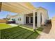 Inviting backyard featuring covered patio, artificial turf, and a hot tub at 856 Watford Pl, Henderson, NV 89011