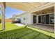 Serene backyard featuring covered patio, artificial turf, and a hot tub at 856 Watford Pl, Henderson, NV 89011