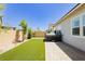 Landscaped backyard featuring lush artificial turf and a modern spa with a sleek, covered design at 856 Watford Pl, Henderson, NV 89011