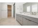 Modern bathroom featuring a double vanity with quartz countertops and sleek gray cabinetry at 856 Watford Pl, Henderson, NV 89011
