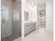 Well-lit bathroom featuring a glass shower, double sink vanity and tile flooring at 856 Watford Pl, Henderson, NV 89011