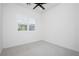 Cozy bedroom with neutral carpet, a window with shutters, and a modern ceiling fan at 856 Watford Pl, Henderson, NV 89011