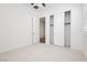 Bright bedroom with plush carpeting, a ceiling fan, and a sliding door closet for ample storage at 856 Watford Pl, Henderson, NV 89011