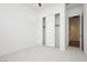 Bright bedroom with neutral carpet, a sliding door closet, and a door leading to another room at 856 Watford Pl, Henderson, NV 89011