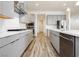 Modern kitchen featuring stainless steel appliances, sleek gray cabinetry, and beautiful wood-look flooring at 856 Watford Pl, Henderson, NV 89011