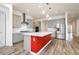 Open-concept kitchen with modern island featuring bar seating, stainless steel appliances, and sleek pendant lighting at 856 Watford Pl, Henderson, NV 89011