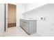 Bright laundry room features gray cabinets, sink, and a doorway to the rest of the home at 856 Watford Pl, Henderson, NV 89011
