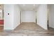 Spacious living area with wood-look flooring, white walls, and access to other rooms in the home at 856 Watford Pl, Henderson, NV 89011