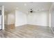 Spacious living room with modern light fixture, light wood flooring and sliding glass doors at 856 Watford Pl, Henderson, NV 89011