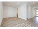 Bright living room features wood-look floors and open layout with views into adjacent rooms and entryway at 856 Watford Pl, Henderson, NV 89011