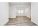 Open-concept living room with wood-look floors, recessed lighting, and a window with plantation shutters at 856 Watford Pl, Henderson, NV 89011