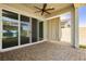Covered patio area with ceiling fan, privacy curtains and large sliding doors to bring the outdoors in at 856 Watford Pl, Henderson, NV 89011