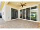 Covered patio featuring stone floors and large sliding glass doors, perfect for outdoor living at 856 Watford Pl, Henderson, NV 89011