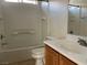 Clean bathroom with a shower-tub combo, white tiling, and a vanity with storage at 8680 Horizon Wind Ave # 101, Las Vegas, NV 89178