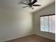 Bright bedroom featuring a ceiling fan, natural light, and soft carpeting at 8680 Horizon Wind Ave # 101, Las Vegas, NV 89178
