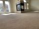 Spacious carpeted living room with fireplace and natural light at 8680 Horizon Wind Ave # 101, Las Vegas, NV 89178