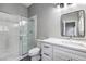 Bathroom featuring glass shower door, white vanity, marble countertop, and black hardware at 8864 La Manga Ave, Las Vegas, NV 89147