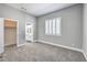 Bedroom with neutral walls, carpet flooring, closet, window, and doorway to bathroom and closet at 8864 La Manga Ave, Las Vegas, NV 89147