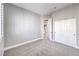 Bedroom features neutral walls, carpet flooring, closet, and doorway to hall with wood flooring at 8864 La Manga Ave, Las Vegas, NV 89147