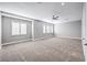 Spacious bonus room has neutral carpet, three windows with shutters, and light grey walls at 8864 La Manga Ave, Las Vegas, NV 89147