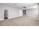 Large bonus room with neutral carpet, light grey walls, ceiling fan, and multiple doorways at 8864 La Manga Ave, Las Vegas, NV 89147