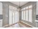 Bright dining area with modern chandelier, beautiful window shutters, and wood look flooring at 8864 La Manga Ave, Las Vegas, NV 89147