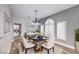 Dining room is well decorated and features a modern chandelier and arched windows with white shutters at 8864 La Manga Ave, Las Vegas, NV 89147