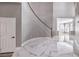 Spacious foyer with marble floors and a curved staircase, creating a grand entrance at 8864 La Manga Ave, Las Vegas, NV 89147