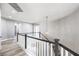 Hallway with wood floors and decorative chandelier at the top of the stairway at 8864 La Manga Ave, Las Vegas, NV 89147