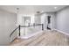 The second story hallway features grey walls, wood flooring, and decorative stairway at 8864 La Manga Ave, Las Vegas, NV 89147