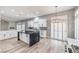 Open kitchen features large island, white cabinets, stone backsplash and pendant lighting at 8864 La Manga Ave, Las Vegas, NV 89147