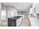 Spacious kitchen with a black marble island, white cabinets, and a view of the living area at 8864 La Manga Ave, Las Vegas, NV 89147
