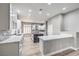 Bright kitchen with white cabinets, marble countertops, and a large center island at 8864 La Manga Ave, Las Vegas, NV 89147