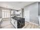 Stylish kitchen with black marble island, white cabinetry, and stainless steel appliances at 8864 La Manga Ave, Las Vegas, NV 89147