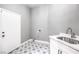 The laundry room boasts a patterned tile floor and a stainless steel sink with chrome faucet at 8864 La Manga Ave, Las Vegas, NV 89147