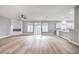 Spacious living room featuring a marble fireplace, ceiling fan, hardwood floors, and an open floor plan at 8864 La Manga Ave, Las Vegas, NV 89147