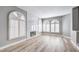 Bright living room features a modern fireplace, hardwood floors, and arched windows with white shutters at 8864 La Manga Ave, Las Vegas, NV 89147