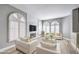 Bright and stylish living room with a fireplace, arched windows, and modern decor at 8864 La Manga Ave, Las Vegas, NV 89147
