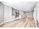 Open floor plan living room featuring hardwood floors, light gray walls, and a modern fireplace at 8864 La Manga Ave, Las Vegas, NV 89147