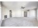 The main bedroom is an empty space that includes carpet flooring, a ceiling fan, multiple windows and a fireplace at 8864 La Manga Ave, Las Vegas, NV 89147