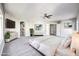The main bedroom is furnished with a large bed, two dressers and a plant and includes carpet flooring at 8864 La Manga Ave, Las Vegas, NV 89147