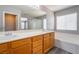 Bright bathroom featuring double sinks, a bathtub, and a separate glass door shower at 9071 Mount Wilson St, Las Vegas, NV 89113