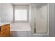 Bright bathroom featuring a soaking tub with tile surround and a separate shower with glass enclosure at 9071 Mount Wilson St, Las Vegas, NV 89113