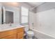 Bathroom featuring a vanity sink, toilet, and a shower-tub combo with white tile surround at 9071 Mount Wilson St, Las Vegas, NV 89113