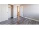 Bedroom with wood floor, fresh paint, white doors and trim, and a view to the bathroom at 9071 Mount Wilson St, Las Vegas, NV 89113